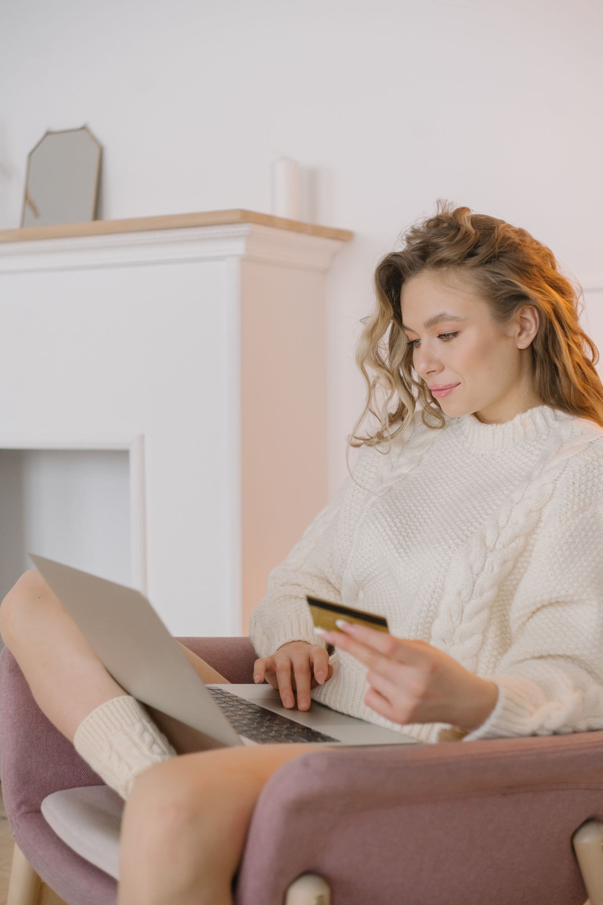 Woman shopping online at home with laptop and credit card